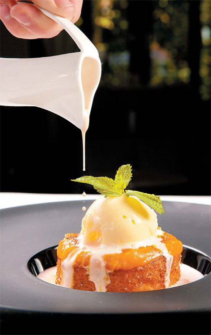 Carrot and pumpkin pudding, caramelized with saffron soup and orange ice cream, is a signature dessert at El Patio. Photos provided to China Daily  