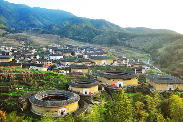 Weiwu (self-encircling houses) scattered in Meizhou, Guangdong province, are one of the most visible examples of the Hakka way of living.[Photo by Huang Lingbo/for China Daily]