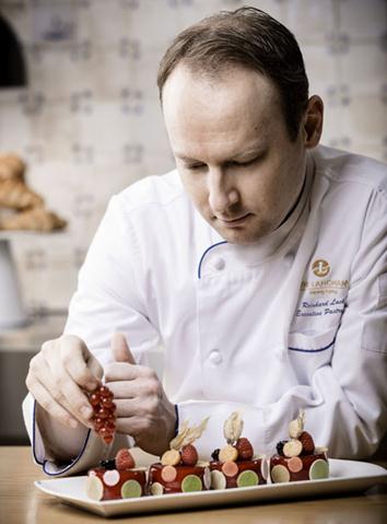 Pastry chef Reinhard Lackner gives final touches to a dessert. Photo provided to China Daily