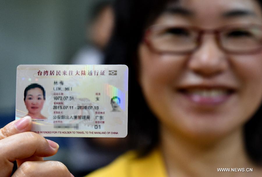 A woman from Taiwan shows her renewed Taibaozheng, a passport-like document that carries the entry permits for Taibao, or Taiwan compatriots, at Changle Airport of Fuzhou, capital of southeast China\'s Fujian Province, Sept. 21, 2015. The electronic version of Taibaozheng, which is in the form of a card instead of the former paper form, is enabled on the Chinese mainland on Monday. The electronic Taibaozheng, which also serves as the certificate of identity during Taiwan residents\' stay on the mainland, will bring more convenience for Taiwanese travelling between Taiwan and the mainland. (Photo: Xinhua/Zhang Guojun)