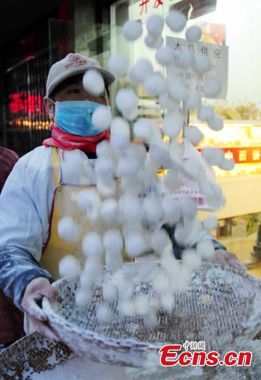 Glutinous rice flour is used to make Yuanxiao with a black sesame seed filling. (Photo/CFP)