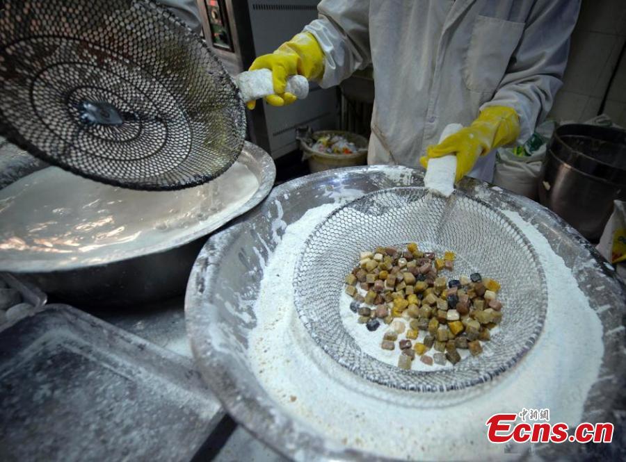 Glutinous rice flour is used to make Yuanxiao with a black sesame seed filling. (Photo: China News Service/Liu Xin)