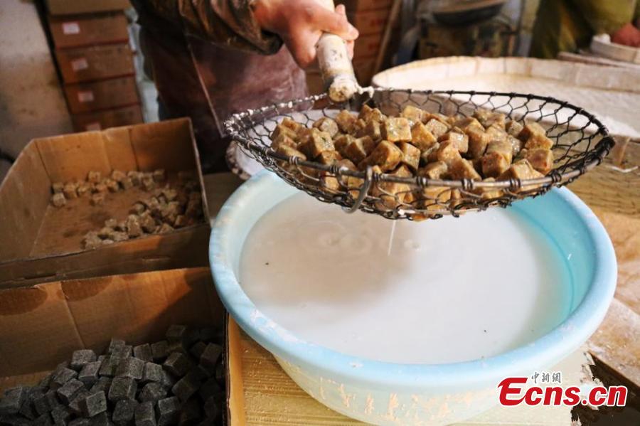 A cook prepares Yuanxiao with black sesame seed as a filling. (Photo: China News Service/Liu Xin)