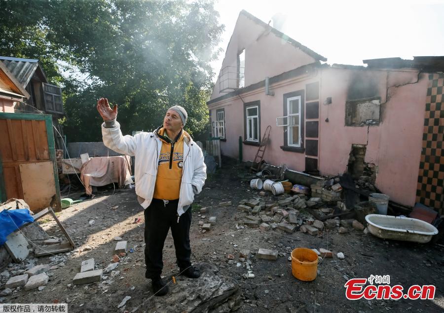 A destroyed house is seen as a local resident stands, near the warehouse storing ammunition for multiple rocket launcher systems at a military base in nearby in Kalynivka, Vinnytsia region, Ukraine September 27, 2017. (Photo/Agencies)