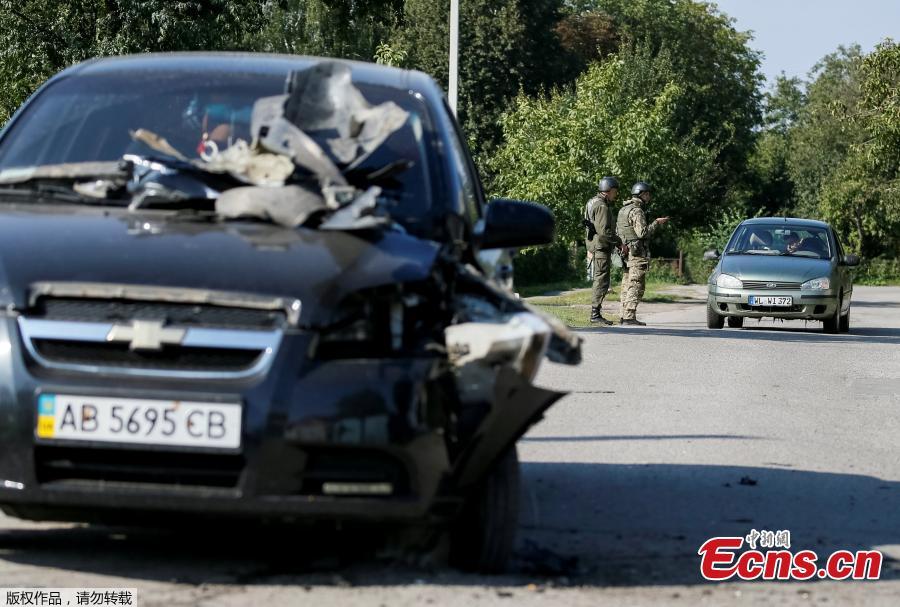 A destroyed car is seen as National Guards patrol the area near the warehouse storing ammunition for multiple rocket launcher systems at a military base in Kalynivka, Vinnytsia region, Ukraine September 27, 2017. (Photo/Agencies)