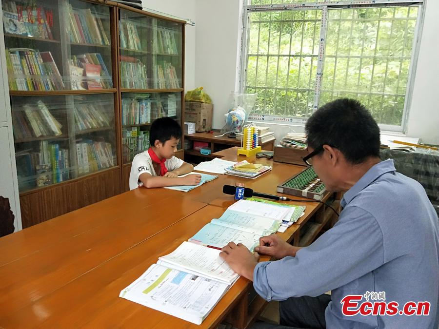 Pan Shanji, 58, is the only teacher at Dayadong Primary School, teaching six subjects to his only student, Li Jianwen, May 31, 2018. Pan began teaching in Sept. 1979 and has taught at three rural primary schools, including 28 years at Dayadong Primary School. (Photo: China News Service/Cao Weijun)