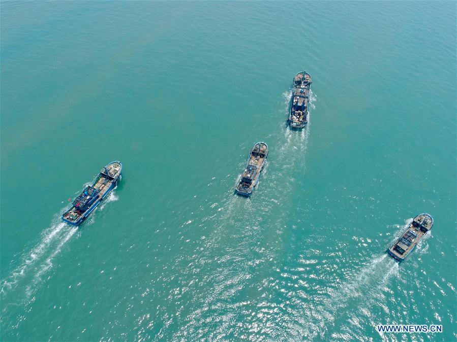 In this aerial photo taken on Aug. 1, 2018, fishing boats depart for fishing in Xiangzhi Town in Shishi City, southeast China\'s Fujian Province. Fishing boats are ready to fish after the three-month fishing ban in Fujian. (Xinhua/Jiang Kehong)