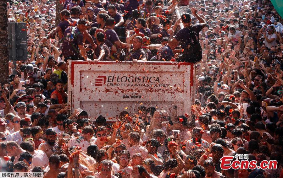 Revellers throw tomatoes during the annual \