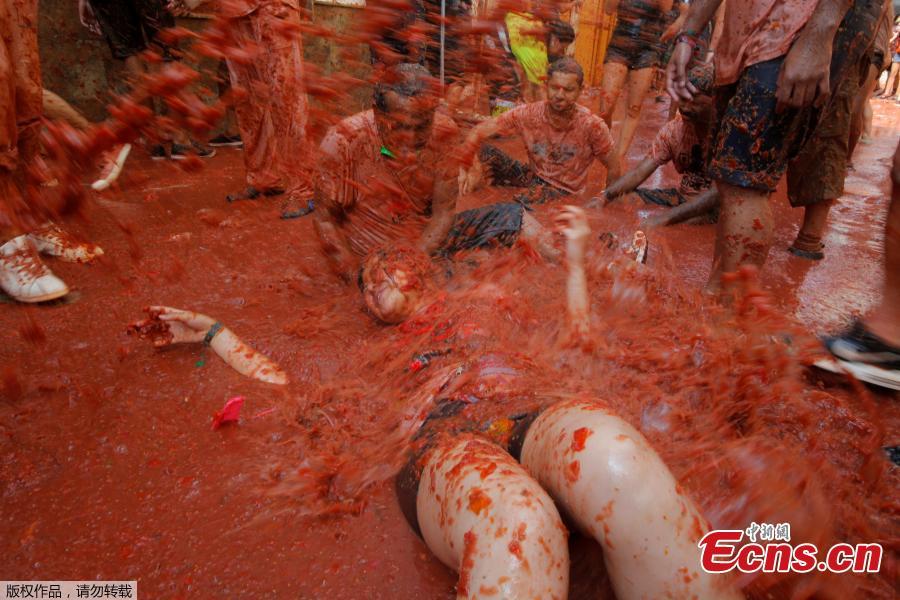 Revellers throw tomatoes during the annual \