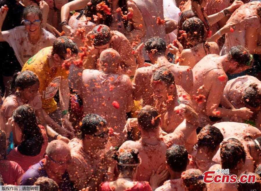 Revellers throw tomatoes during the annual \