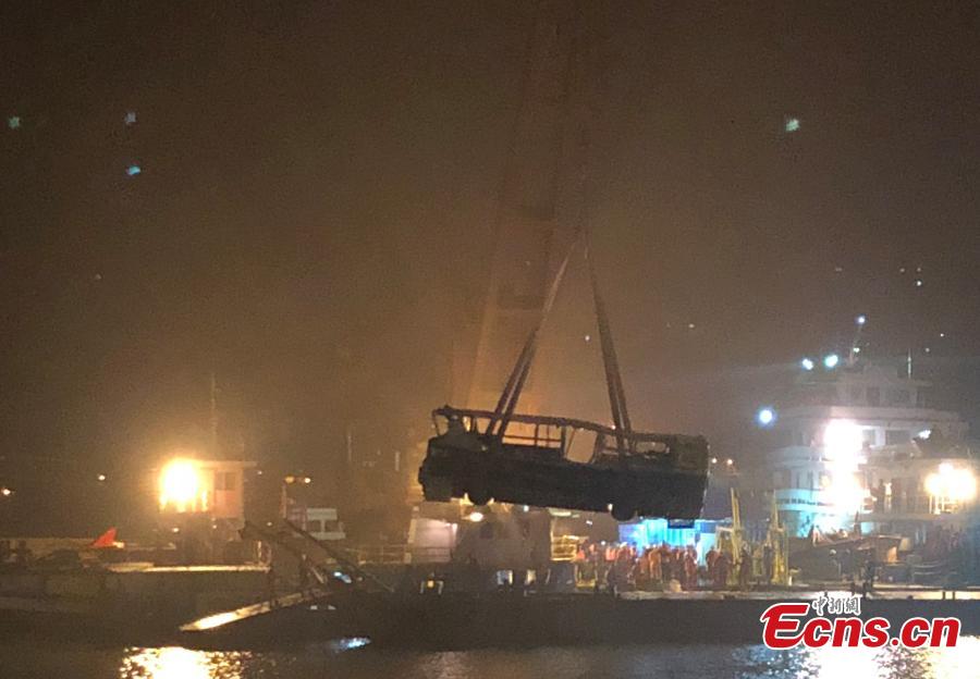 Rescuers on Wednesday night salvaged the wreck of a bus that plunged into the Yangtze River in Chongqing Municipality leaving at least nine people dead. The bus was pulled out of water by a floating crane at about 11:30 p.m.. Rescuers are expected to enter the bus to search for bodies of victims. The bus veered onto the wrong side of the road and collided into an oncoming car before breaking through road fencing and falling off a bridge in Chongqing\'s Wanzhou District on Sunday.