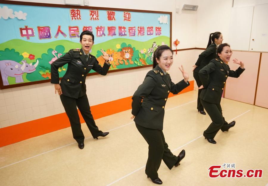 Members of the PLA troops stationed in Hong Kong perform for children at Ka Fuk Baptist Church Pre-School to celebrate the upcoming Spring Festival, China\'s Lunar New Year, in Hong Kong, Jan. 24, 2019. (Photo: China News Service/Zhang Wei)