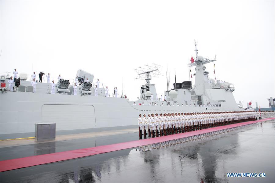 The honor guards of the Chinese People\'s Liberation Army (PLA) Navy stand in formation before a naval parade staged to mark the 70th founding anniversary of the PLA Navy at a pier in Qingdao, east China\'s Shandong Province, on April 23, 2019. (Xinhua/Li Gang)