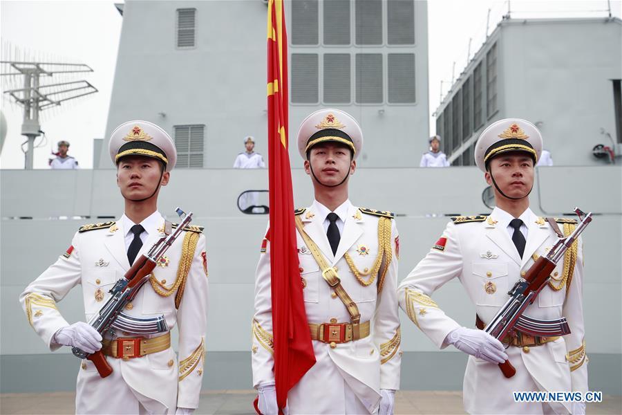 The honor guards of the Chinese People\'s Liberation Army (PLA) Navy stand in formation before a naval parade staged to mark the 70th founding anniversary of the PLA Navy at a pier in Qingdao, east China\'s Shandong Province, on April 23, 2019. (Xinhua/Li Gang)