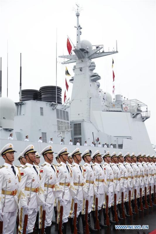 The honor guards of the Chinese People\'s Liberation Army (PLA) Navy stand in formation before a naval parade staged to mark the 70th founding anniversary of the PLA Navy at a pier in Qingdao, east China\'s Shandong Province, on April 23, 2019. (Xinhua/Li Gang)