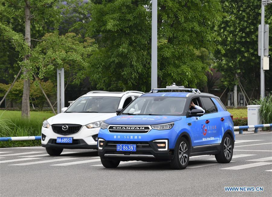 A car (R) is controlled by a remote operator during a test run in Chongqing, southwest China, May 15, 2019. A remote-controlled car powered by the 5G network completed a test run on Wednesday in Chongqing. During the test run, a remote operator was able to control the car while watching the live feed of road conditions supported by the 5G network. (Xinhua/Liu Chan)