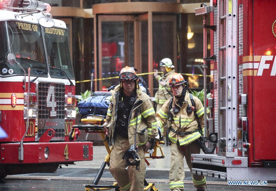 Rescuers walk out of the building where a helicopter crashed in Manhattan, New York, the United States, June 10, 2019. One person was killed after a helicopter crashed onto the roof of a skyscraper in Midtown Manhattan of New York City Monday afternoon, according to media reports. (Xinhua/Wang Ying)