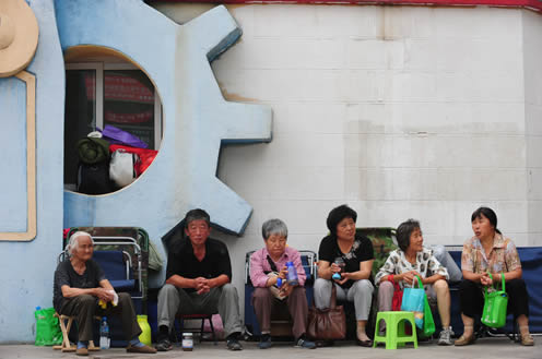 Parents and grandparents are waiting for their child's admission to a kindergarten.