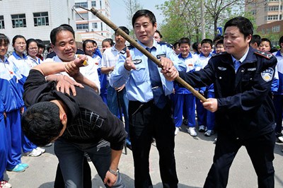 Policemen teach self-defense skills in schools after the eruption of campus violence last year. 