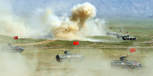 Armored cars and Chinese soldiers participate in the Peace Mission 2012 anti-terror drill held by Shanghai Cooperation Organization countries in Tajikistan on Thursday. The drill involved about 2,000 military personnel from China, Kazakhstan, Kyrgyzstan, Russia and Tajikistan. Photos by Li Jing / For China Daily