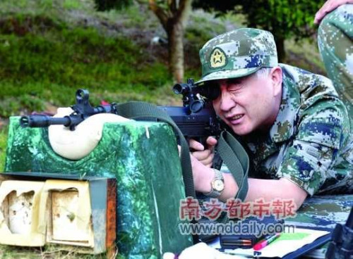 Wang Yang, Party secretary of Guangdong province shoots a rifle during a Military Day on Aug 1, 2012 at a camp in the province.