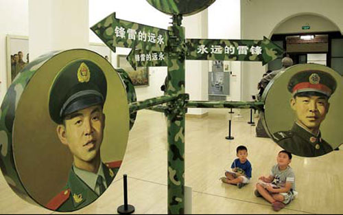 Kids enjoy the military art exhibition at the National Art Museum of China, in Beijing. 