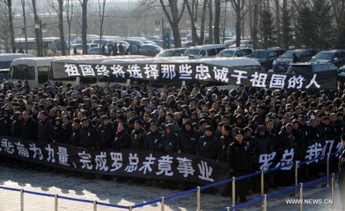 People attend a memorial service for Luo Yang, head of the production phase for China's new J-15 fighter jet, who died of a heart attack on Nov. 25, in the Huilonggang Cemetery for Revolutionaries in Shenyang, capital of northeast China's Liaoning Province, Nov. 29, 2012. Luo experienced a heart attack after observing aircraft carrier flight landing tests for China's first aircraft carrier, the Liaoning, on Nov. 25. He later died in hospital at the age of 51. He was also chairman and general manager of Shenyang Aircraft Corp. (SAC), a subsidiary of China's state-owned aircraft maker, Aviation Industry Corp. of China (AVIC). (Xinhua/Yang Qing)