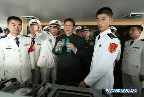 General Secretary of the Communist Party of China (CPC) Central Committee Xi Jinping (C), who is also the chairman of the CPC Central Military Commission, examines onboard the Navy destroyer Haikou during his inspection at the Guangzhou military theater of operations of the People's Liberation Army (PLA), Dec. 8, 2012. Xi made an inspection at the PLA's Guangzhou military theater of operations, a term usually used to emphasize the coordination and joint operations by forces in air, land and sea, from Dec. 8 to 10. (Xinhua/Wang Jianmin)