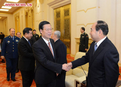 Zhang Gaoli (C), a member of the Standing Committee of the Political Bureau of the Communist Party of China (CPC) Central Committee, attends a high-profile symposium held to mark a movement initiated by late Chinese leader Mao Zedong to boost military-government and military-civilian solidarity 70 years ago, in Beijing, capital of China, Jan. 25, 2013. (Xinhua/Liu Jiansheng)