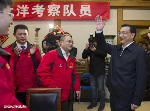 Chinese Vice Premier Li Keqiang (R, front) greets staff members of the State Oceanic Administration in Beijing, capital of China, Feb. 7, 2013. Li greeted staff of the State Oceanic Administration ahead of the Lunar New Year holiday. He also extended festival greetings via satellite video to scientists performing duties in polar regions and on the ocean, and visited representatives of scientific expeditions stationed in Beijing and their family members. (Xinhua/Wang Ye)