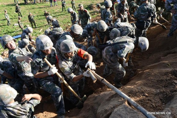 Rescuers work at Yongguang Village of Meichuan Town in Minxian County, northwest China's Gansu Province, July 22, 2013. The death toll has climbed to 89 in the 6.6-magnitude earthquake which jolted a juncture region of Minxian County and Zhangxian County in Dingxi City Monday morning. (Xinhua/Zhang Yongjin) 