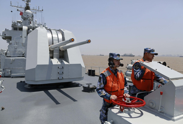 Chinese destroyer Harbin sets off on Thursday for the Joint Sea-2014 drill between Chinese and Russian navies. Fourteen ships, two submarines, nine fixed-wing aircraft and six helicopters from the two militaries are taking part in the weeklong drill that started on Tuesday. Feng Yongbin / China Daily