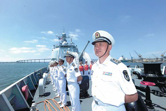 Officers and sailors line up on board the missile destroyer Haikou as the vessel arrives on Sunday at the US naval base in San Diego for a five-day visit. Hu Kaibing / Xinhua