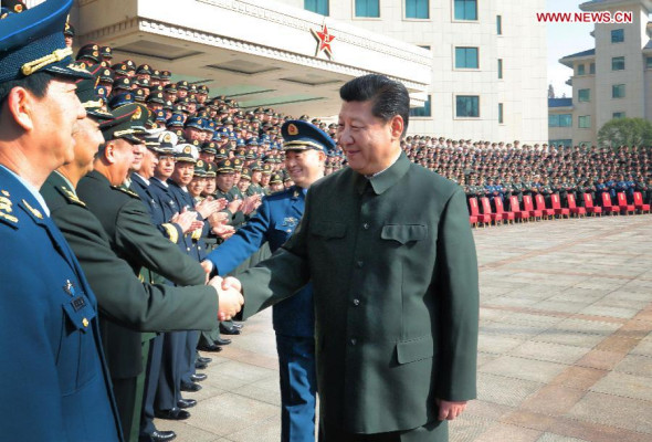 Chinese President Xi Jinping (R), also general secretary of the Communist Party of China (CPC) Central Committee and chairman of the Central Military Commission, meets with senior officers of the Nanjing Military Area Command during an inspection tour in east China's Jiangsu province, Dec 14, 2014. (Xinhua/Li Gang)