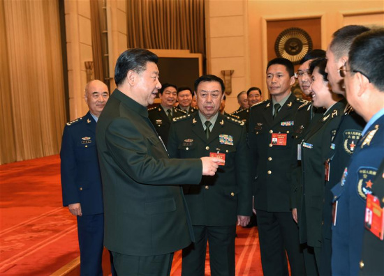 Chinese President Xi Jinping, also general secretary of the Communist Party of China Central Committee and chairman of the Central Military Commission, meets with deputies from grassroots units to the 12th National People's Congress (NPC) after a panel discussion in Beijing, capital of China, March 12, 2017. (Xinhua/Li Gang) 