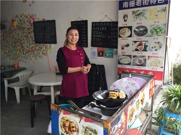 Wu Dongyun sells stinky-tofu rolls and other local food at a small diner in Nanzha.