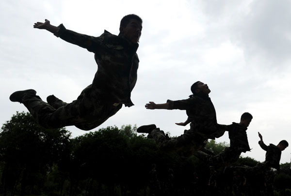 An armed police detachment conduct a military training exercise to celebrate the upcoming Army Day in Tongling, East China's Anhui province on July 24, 2014. Army Day falls on August 1 each year, marking the anniversary of the founding of the Chinese People's Liberation Army on August 1, 1927. [Photo/Xinhua]