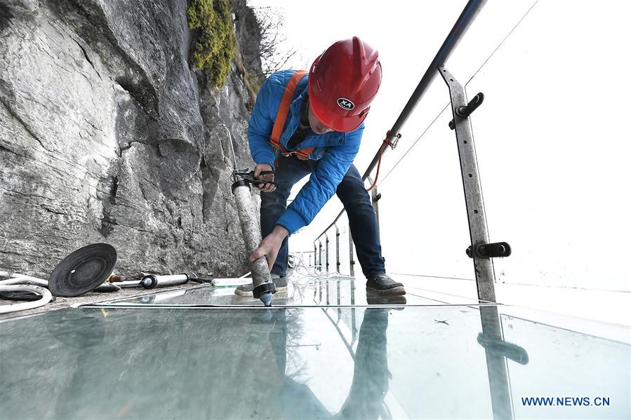 Workers replace glass pavement at Tianmenshan scenic area in Hunan