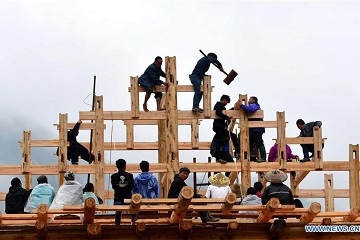 Villagers build wooden Diaojiaolou houses in S China's Guangxi
