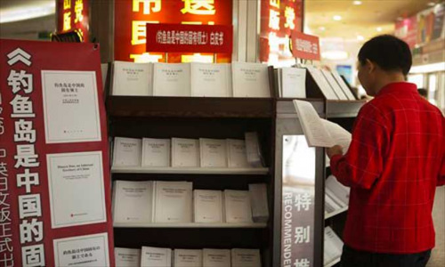 A man reads the white paper on the Diaoyu Islands at a bookstore in downtown Beijing on Friday. The white paper, entitled Diaoyu Islands, an Inherent Territory of China, published in Chinese, English and Japanese, hit the market on Friday. It has been issued both at home and abroad to assert China's sovereignty over the island and its affiliated islets. Photo: Guo Yingguang/GT 