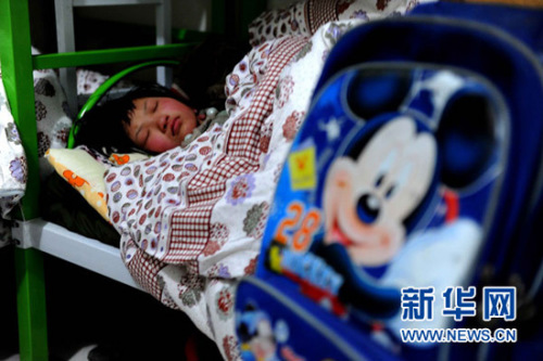 A child is in government custody following a fatal fire that destroyed an unregistered orphanage in north China's Henan Province on Jan 04, 2012.(Photo/Xinhua)