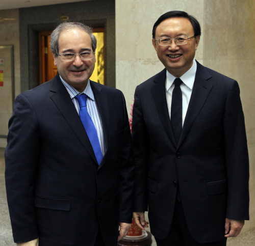 Foreign Minister Yang Jiechi (right) meets Syrian Vice-Minister of Foreign Aff airs Faisal al-Makdad in Beijing on Wednesday. [ZHANGWEI / CHINA DAILY]