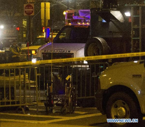 An ambulance and armored car sit at the scene of the explosion which killed three people in Boston, theUnited States, April 15, 2013. The two explosions that rocked the Boston Marathon on Monday has killed three people and injured at least 138, officials and media outlets said. (Xinhua/Marcus DiPaola)