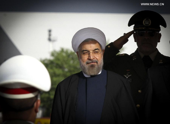 Iranian President Hassan Rouhani (C) inspects the honour guards before leaving for China at Mehrabad Airport in Tehran, Iran, on May 20, 2014. Rouhani left Tehran for Shanghai on Tuesday morning to attend the Conference on Interaction and Confidence Building Measures in Asia (CICA) summit, to be held in Shanghai on May 20-21. (Xinhua/Ahmad Halabisaz)