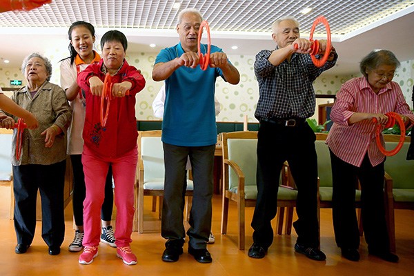 enior citizens take exercises at a care home in Beijing. The number of beds at such institutions is far from sufficient in the capital. (Jiang Dong/China Daily)