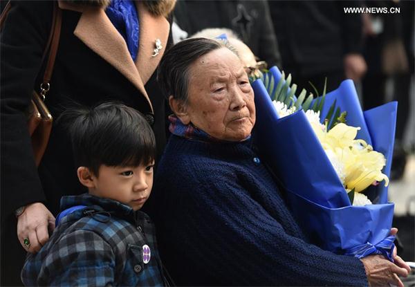 Xia Shuqin (R), a survivor of the Nanjing Massacre, and her family members mourn the victims at the Memorial Hall of the Victims in Nanjing Massacre by Japanese Invaders in Nanjing, capital of East China's Jiangsu province, Dec 3, 2016. (Photo/Xinhua)