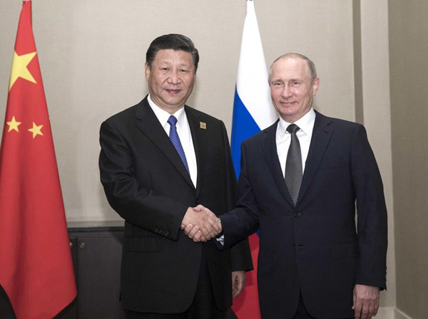 Chinese President Xi Jinping shakes hands with Russian President Vladimir Putin during their meeting as part of the Shanghai Cooperation Organization (SCO) summit in Astana, Kazakhstan, June 8, 2017. (Photo/Xinhua)